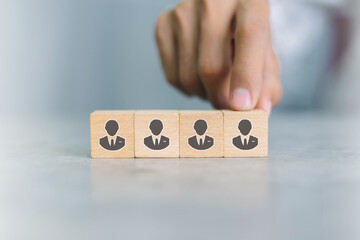 Recruiter complete team represented by wooden cube by one leader person (CEO) and icon,human...