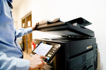 Bussiness man Hand press button on panel of printer, printer scanner laser in office copy machine supplies start concept.