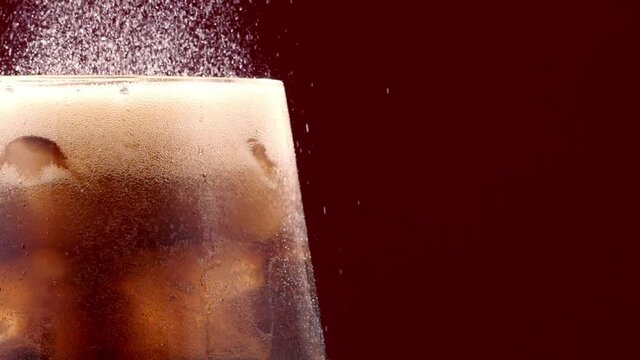 Slow Motion Of Pouring Cola Drink With Ice Cubes Inside close-up 300 fps