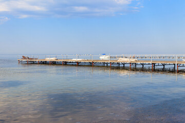 Fototapeta na wymiar Wooden pier in the Black sea in Skadovsk, Ukraine