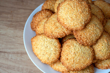 Sesame cookies on a plate. Pile, heap of sesame cookies.  Delicious and sweet sesame cookies.