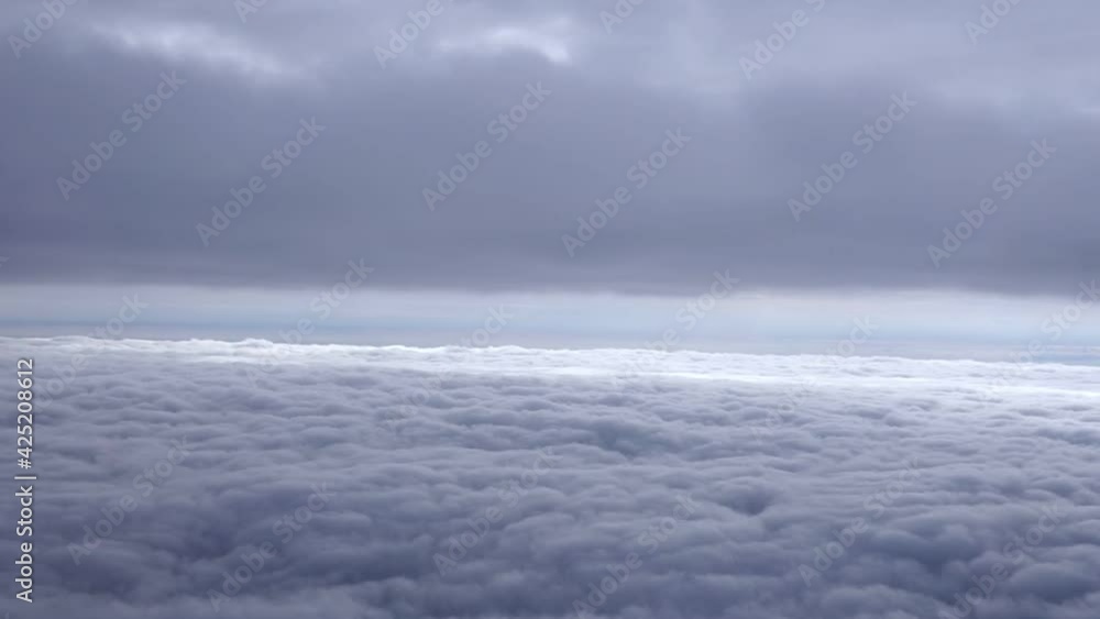 Wall mural beautiful blue sky above clouds with warm sunlight view from plane
