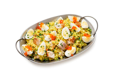 Traditional british cuisine. Fresh prepared kedgeree with smoked haddock and boiled egg. Served with fresh parsley and red caviar.  isolated on white background