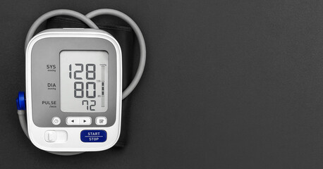 Medical electronic tonometer on black background. Top view. Space for text.