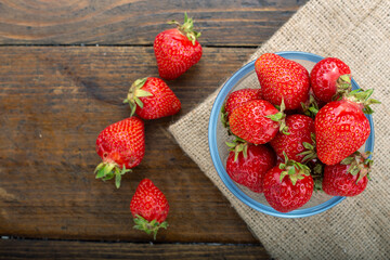 Ripe red strawberries on wooden table