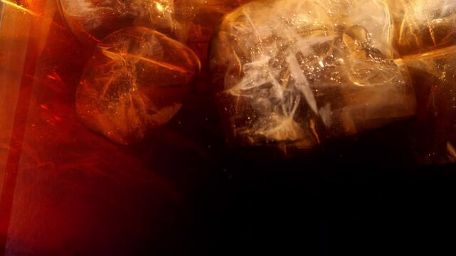 Slow Motion Of Pouring Cola Drink With Ice Cubes Inside, Close-up 300 fps