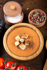 Fototapeta na wymiar Gazpacho soup on a wooden table.