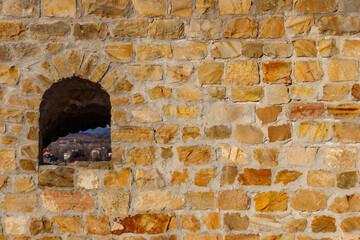 Background of the old stone wall with a loophole