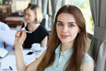 beautiful woman have meeting with her subordinates in cafe