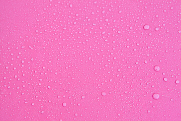 Full frame of the textures formed by the bubbles and drops of water. Drops of water spilled on a light pink surface