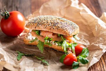 Close up of a sandwich with salmon, lettuce (arugula) and wholemeal bread