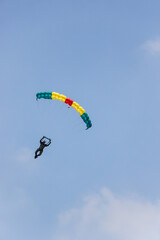 Skydiver On Colorful Parachute in blue sky