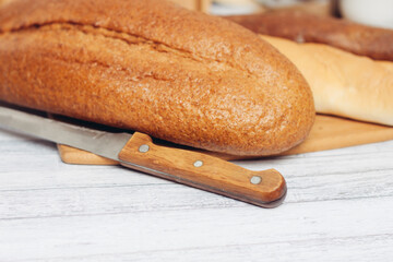 bread on a wooden table kitchen knife baking