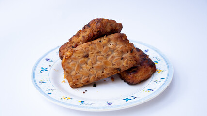 Close up of tempe bacem. Traditional foods from Java, Indonesia. Made from soya bean. isolated on white background 