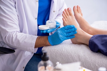 Podiatrist treating feet during procedure