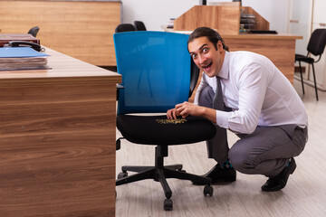Ofice prank with sharp thumbtacks on chair