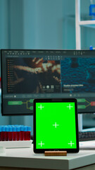 Team of scientists working in background of modern laboratory using tablet with green screen, mockup display, isolated chroma key monitor, analysing experiment evolution, high tech development lab.