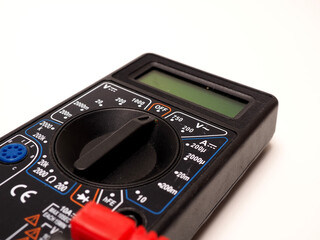 Picture of black digital multimeter or AVO meter for measuring electrical stuff such as voltage, resistance, and current. Shoot on a white isolated background