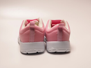 Closeup shoot pair of pink girl shoe. Shoot on white isolated background