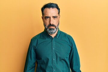 Middle age man with beard and grey hair wearing business clothes depressed and worry for distress, crying angry and afraid. sad expression.