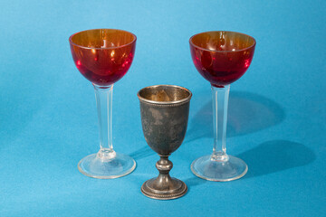 glass and metal glasses photographed on a blue background