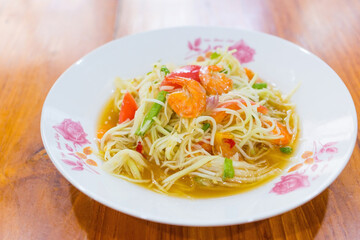 Papaya salad is a spicy salad made from shredded unripe papaya. Originating from ethnic Lao people, it is also eaten throughout Southeast Asia. It is Thai style food.