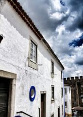 Narrow and colorful streets, facades and balconies of Obidos