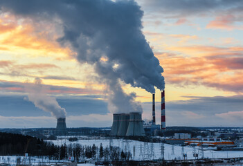 thermal power plant and cooling towers near the city in winter