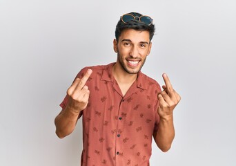 Fototapeta premium Young handsome man wearing casual summer clothes showing middle finger doing fuck you bad expression, provocation and rude attitude. screaming excited