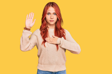 Young redhead woman wearing casual winter sweater swearing with hand on chest and open palm, making...