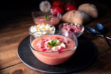 
Salmorejo, cold tomato soup typical of Spanish cuisine in summer. Tomato soup with boiled egg and Serrano ham, typical of Andalusian cuisine. Food photography