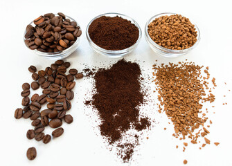 Coffee beans ground and instant in glass bowls on a white background. View from above