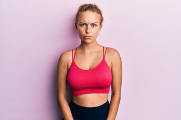 Beautiful caucasian woman wearing sportswear skeptic and nervous, frowning upset because of problem. negative person.