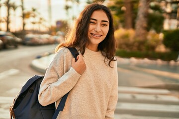 Fototapeta premium Young middle east student girl smiling happy standing at the city.