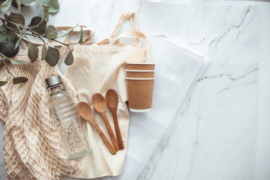 Plastic Free Set With Eco Cotton Bag, Glass Jar, Green Leaves And Recycled Tableware Top View. Zero Waste, Eco Friendly Concept. Zero Waste Shopping Bags