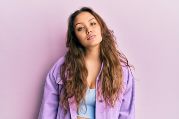 Fototapeta premium Young hispanic girl wearing casual clothes relaxed with serious expression on face. simple and natural looking at the camera.
