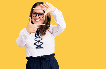 Young beautiful caucasian woman wearing business shirt and glasses smiling making frame with hands and fingers with happy face. creativity and photography concept.