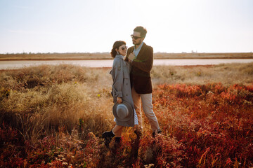 Stylish and loving couple enjoying each other outdoors. Enjoying time together. The concept of...