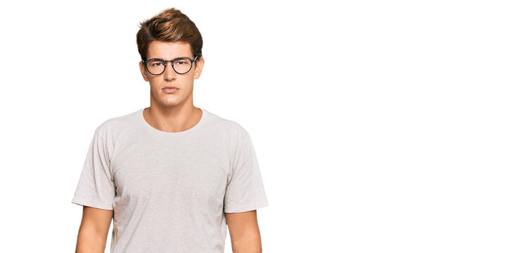 Handsome caucasian man wearing casual clothes and glasses relaxed with serious expression on face. simple and natural looking at the camera.