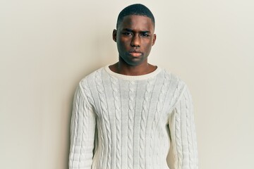 Obraz premium Young african american man wearing casual clothes looking sleepy and tired, exhausted for fatigue and hangover, lazy eyes in the morning.