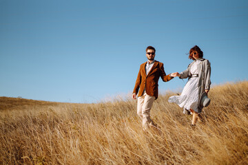 Stylish and loving couple enjoying each other outdoors. Enjoying time together. The concept of youth, love and lifestyle. Springtime.