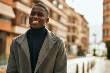 Young african american man smiling happy standing at the city