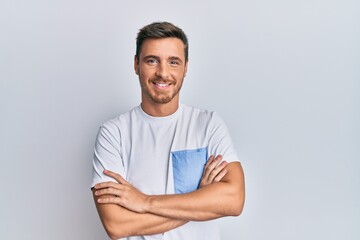 Handsome caucasian man wearing casual clothes happy face smiling with crossed arms looking at the...