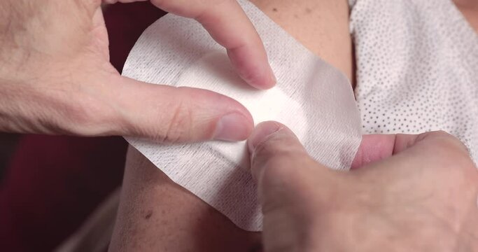 Covering arm's sutured wound at home after medication