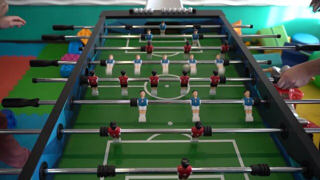 Foosball. Hands of a man playing table football