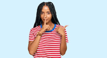 Fototapeta na wymiar Beautiful hispanic woman wearing casual clothes asking to be quiet with finger on lips pointing with hand to the side. silence and secret concept.