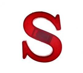 Plastic letter S on magnet isolated on white background, top view