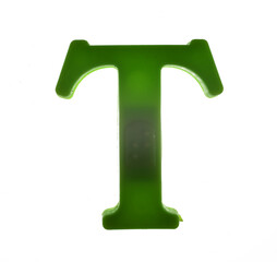Plastic letter T on magnet isolated on white background, top view