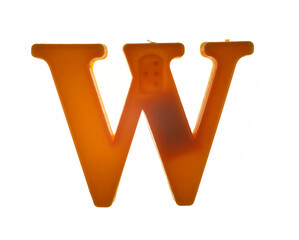 Plastic letter W on magnet isolated on white background, top view
