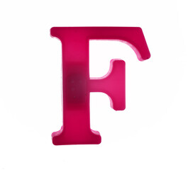 Plastic letter F on magnet isolated on white background, top view